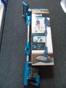 A Shark Flexology cord free electric vacuum with charger and box together with a Dremel multitool
