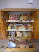 A 20th century pine double door workshop cabinet containing continental hand tools,