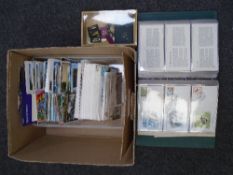 A box containing postcards, commemorative coins, First Day Covers etc.