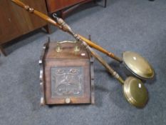 An Edwardian carved coal receiver together with two beech handled brass headed bedwarming pans.