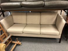 A late 20th century wood framed beige fabric three seater settee