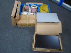 Two plastic crates containing wire, an Excel cabinet plinth (boxed),