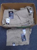 A box containing a quantity of Dickies work trousers
