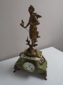 An antique French onyx mantel clock surmounted by a figure Chasse Aux Papillons Par Ferrand,