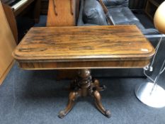 A Victorian rosewood turnover top pedestal tea table.
