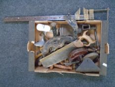A box of vintage tools including a large vice, shoe lasts, saws etc.