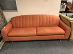 A 20th century continental settee in orange fabric