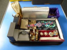 A tray of costume jewellery, evening bags,