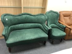 A 1930's Art Deco shaped backed settee in green floral fabric together with similar armchair