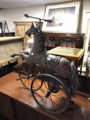 A Victorian style horse tricycle.