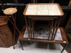 A mid century Danish tiled coffee table together with a further nest of tiled tables and bamboo