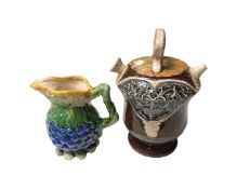 A majolica style grape design jug together with a further majolica style pot