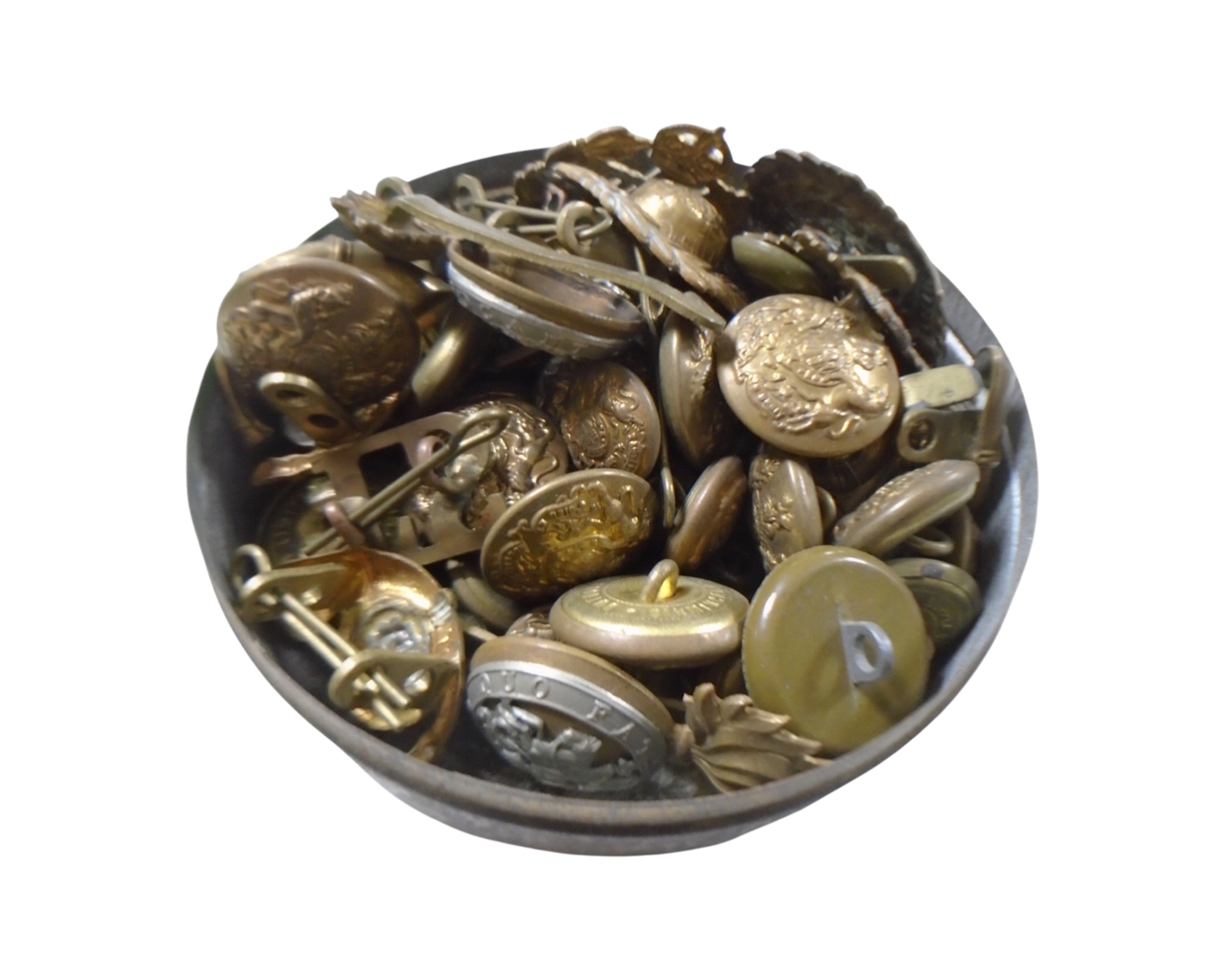 A tin containing a collection of military buttons and badges.