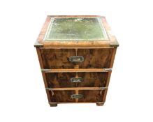 An inlaid yew wood ship's style three drawer chest with leather inset panel,