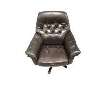 A 1970's Danish brown leather buttoned backed armchair