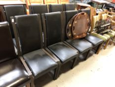 A set of eight wood framed high backed dining chairs in black vinyl