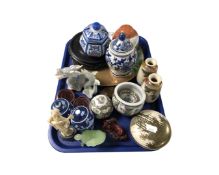 A tray containing Oriental porcelain and resin figures,