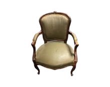 A French carved beech framed salon armchair in brown fabric