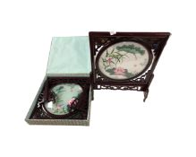 A Chinese embroidered silk table screen, in frame and stand, together with a further boxed screen.