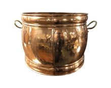 A twin-handled copper cooking pot