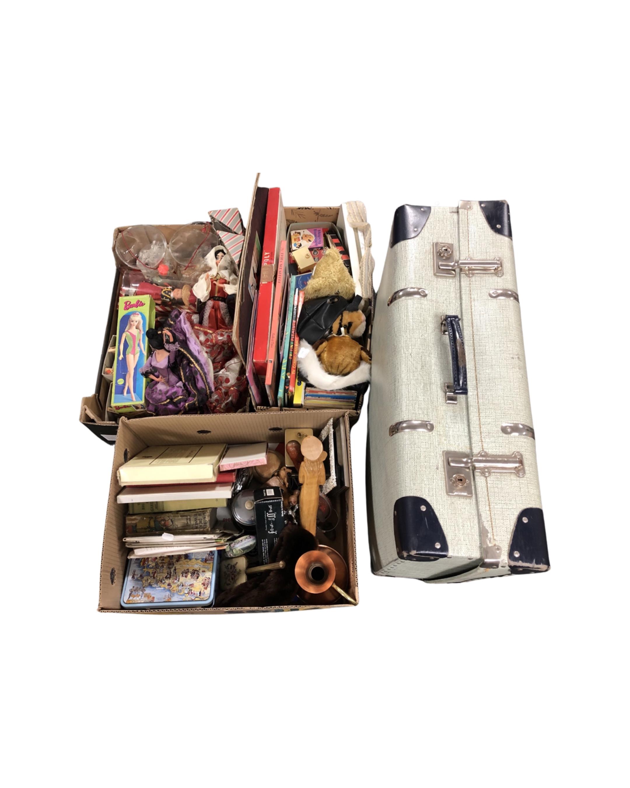 A vintage luggage case together with three boxes containing world dolls, boxed Barbie doll,