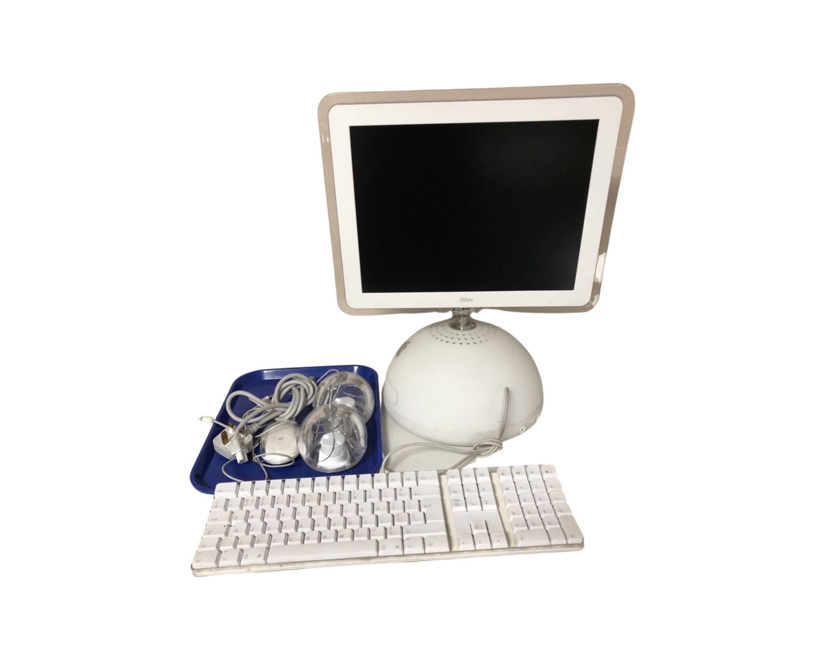 A 2003 Apple iMac computer with keyboard, speakers and mouse.