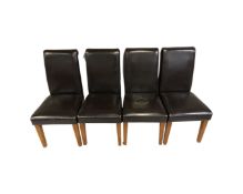 A set of four contemporary high backed dining chairs in brown leather
