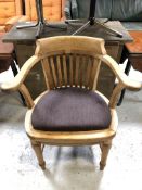 An Edwardian oak smoker's armchair