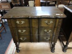 A Continental oak and beech three drawer chest on raised legs,