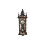 A 19th century mahogany cased Vienna wall clock with pendulum and key (af)
