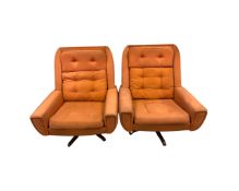 A pair of 1970's Danish swivel armchairs in orange buttoned fabric