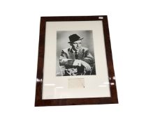 A monochrome photograph of Frank Sinatra with proof stamp in frame