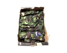 A box of camouflage jackets etc bearing military badges