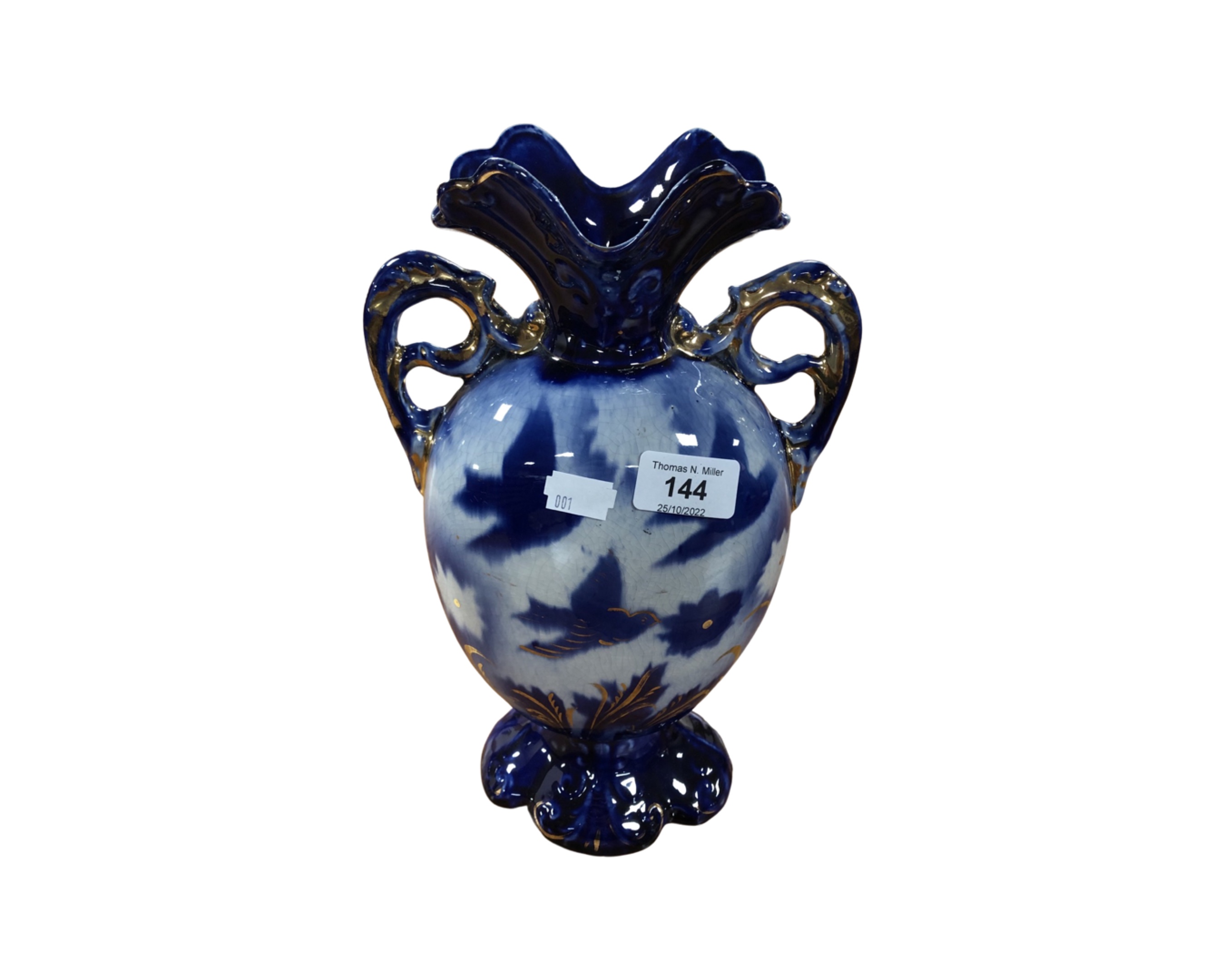 An antique gilded porcelain twin-handled vase.