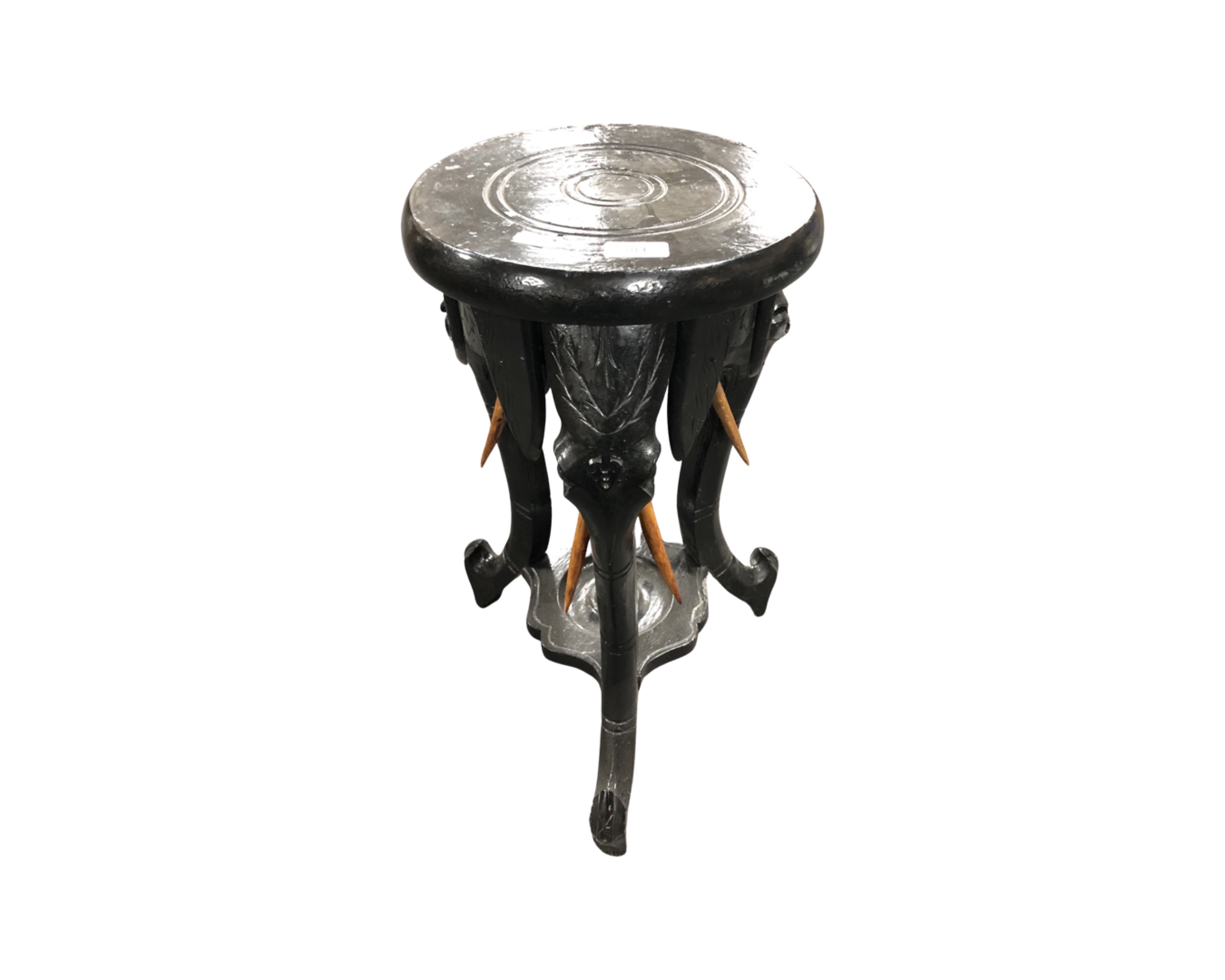 An ebonised elephant plant stand