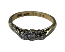 An 18ct gold and platinum three stone diamond ring, size N CONDITION REPORT: 2.