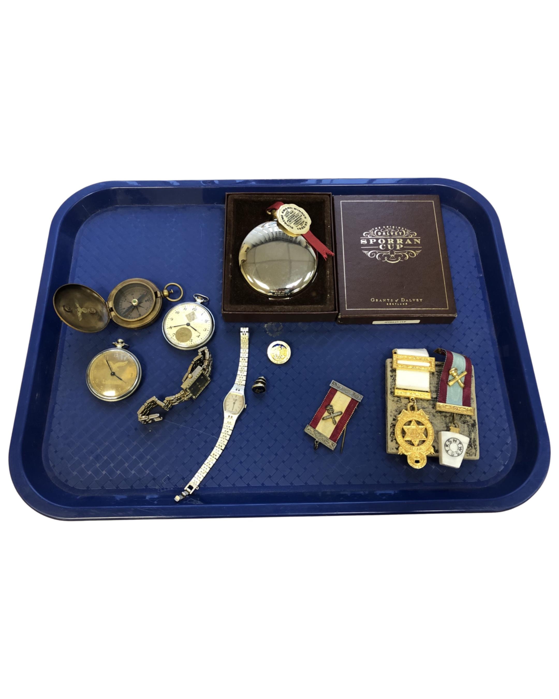 A tray containing reproduction German compass and pocket watches, sporran cup, medals,