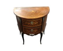A Kingwood D-shaped two drawer chest with ormolu mounts on raised legs,