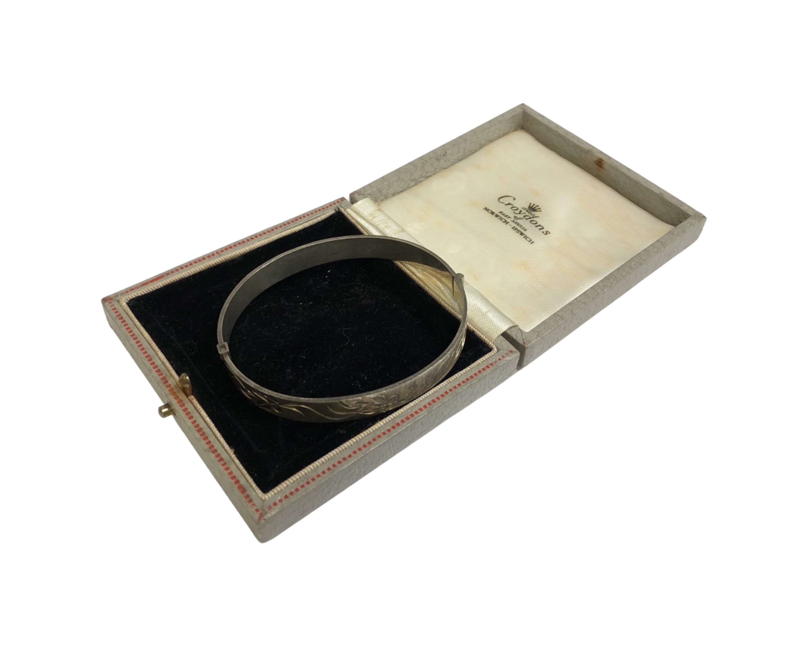 A silver bangle with textured sides and oversized hallmark, Bracelon Ltd, Birmingham 1977, 17. - Image 2 of 2