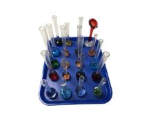A tray containing approximately 20 assorted 1970's coloured glass bud vases.