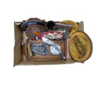 A box of continental wall plaques, brass shell casing, wall clock,