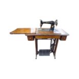 A 20th century Singer sewing machine in table,