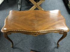A French walnut shaped coffee table on cabriole legs,