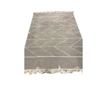 A contemporary kilim rug on grey ground,