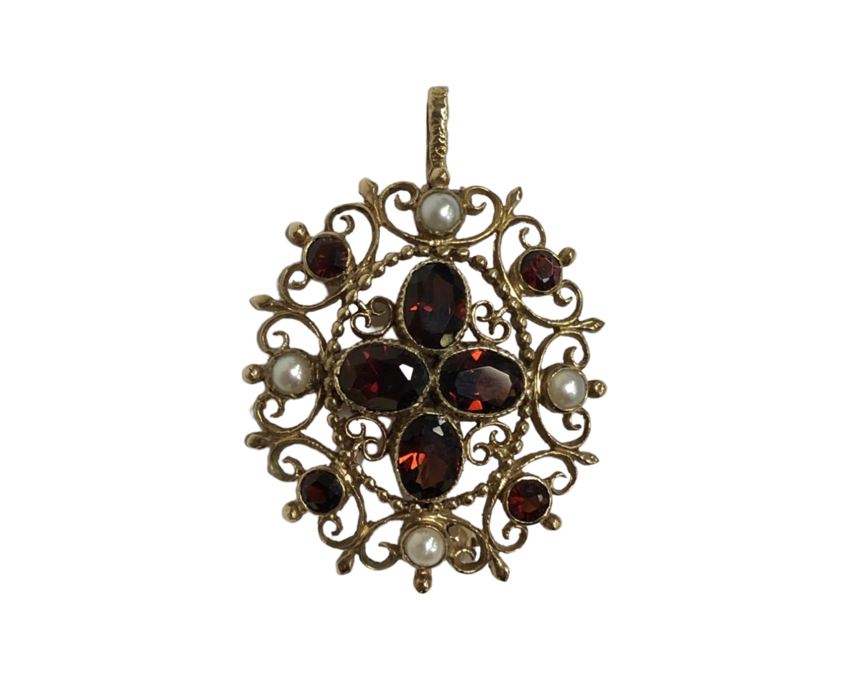 A 9ct yellow gold garnet and seed pearl brooch / pendant, 7.8g, 40 mm (inc bale) x 29 mm.