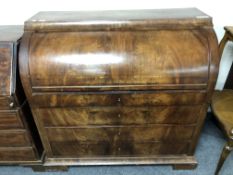 A 19th century mahogany barrel fronted bureau fitted with four drawers,