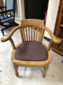 An Edwardian oak smoker's armchair