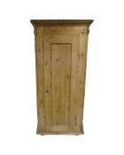 An antique pine sentry door cabinet with internal shelves,