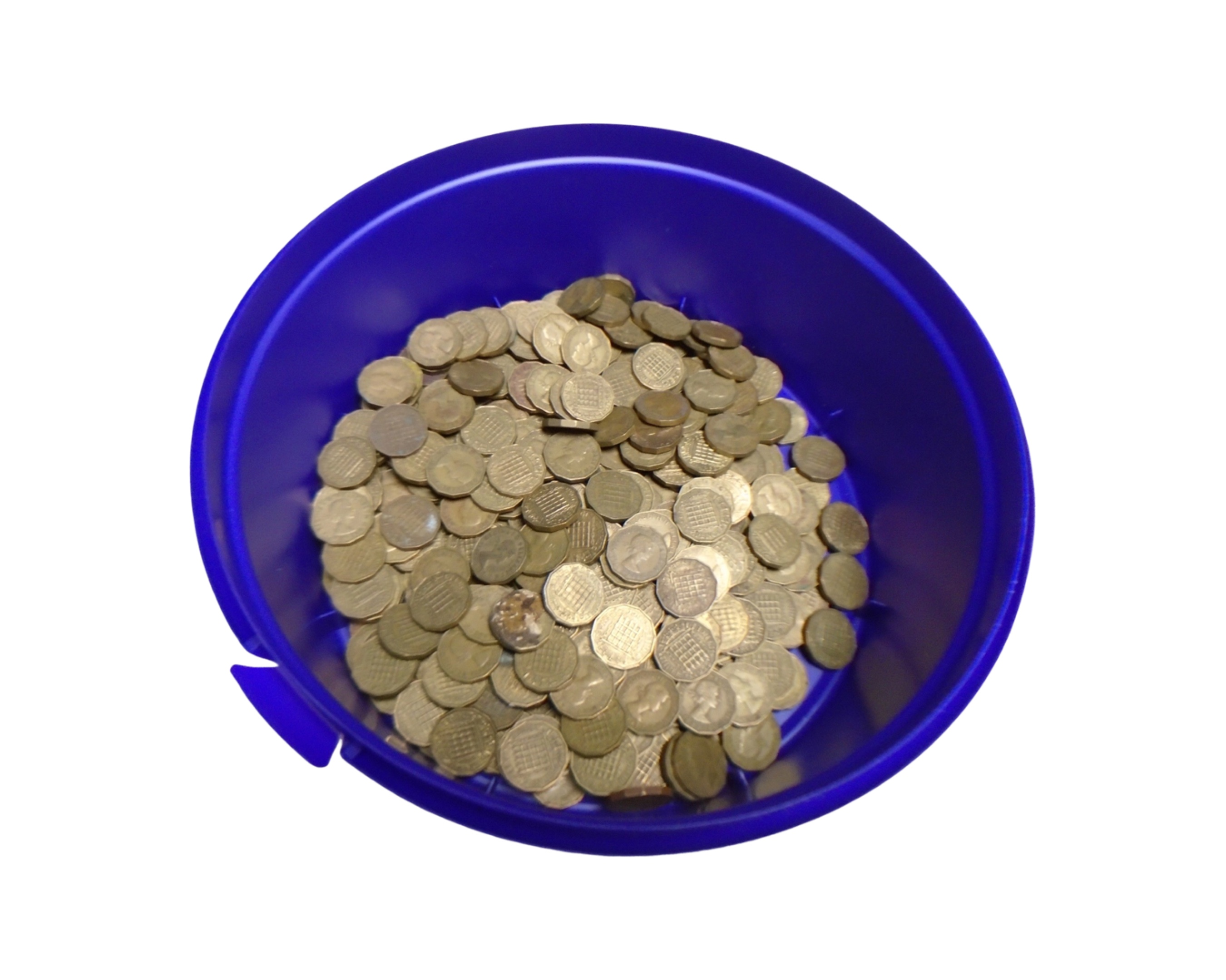 A tub containing a quantity of three pence pieces