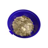 A tub containing a quantity of three pence pieces